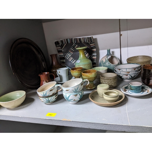 293 - A mixed lot of studio pottery to include an Edward Hughes cup and saucer A/F, St Ives Leach celadon ... 