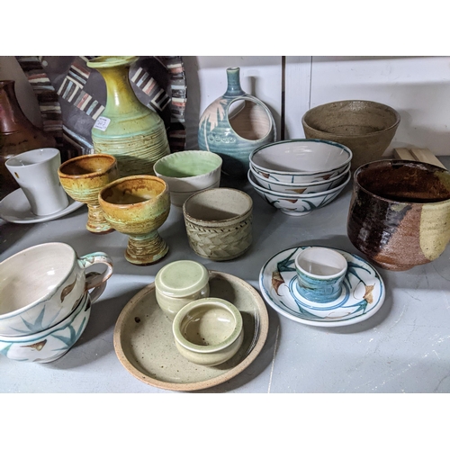 293 - A mixed lot of studio pottery to include an Edward Hughes cup and saucer A/F, St Ives Leach celadon ... 