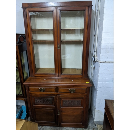 317 - A late Victorian/Edwardian mahogany side cabinet/bookcase, the top with twin glazed doors, adjustabl... 