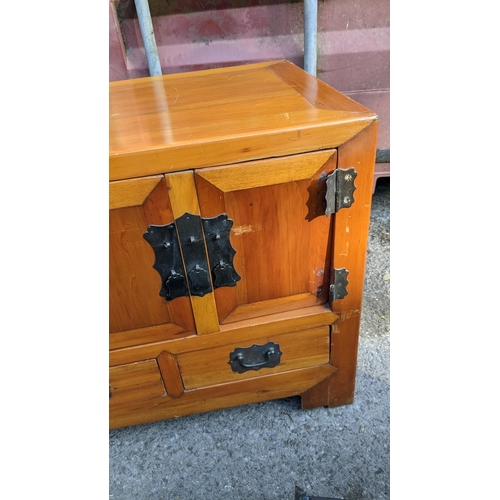 128 - A late 20th century Chinese softwood cabinet with four doors and four drawers, 62cm h x 134cm l
Loca... 