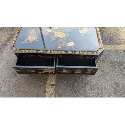 129 - A late 20th century Chinese black lacquered painted and gilt coffee table with four drawers
Location... 