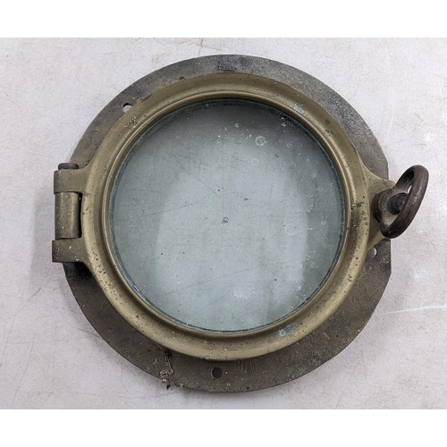 134 - A 20th century cast bronze ships port hole with a hinged glazed doors, 35cm dia
Location: A4B

If th... 