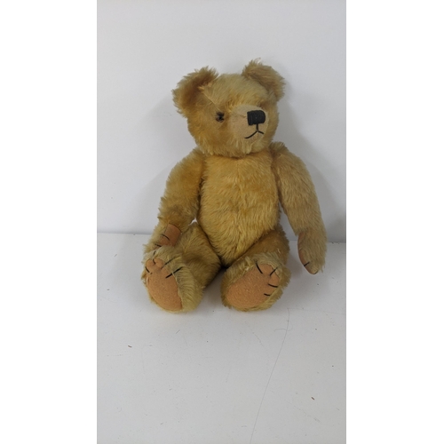 190 - A 1930's Farnell teddy bear with gold coloured mohair, kapok stuffed, having amber and black glass e... 