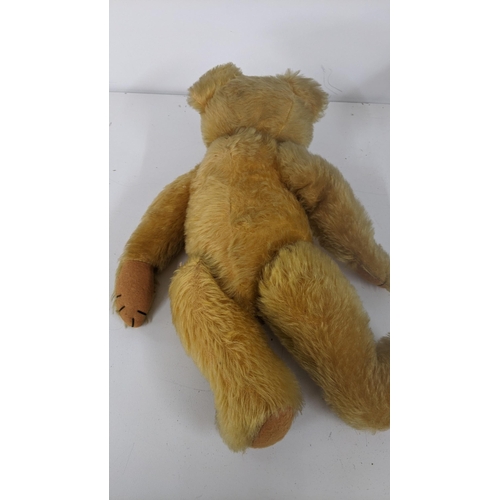 190 - A 1930's Farnell teddy bear with gold coloured mohair, kapok stuffed, having amber and black glass e... 