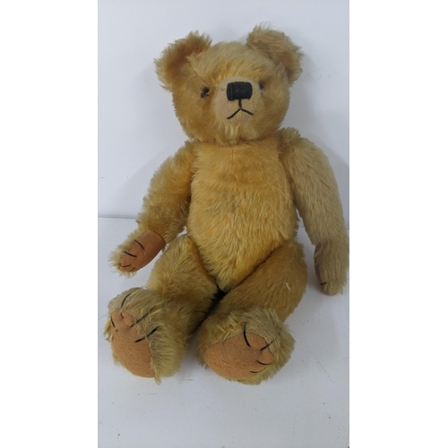 190 - A 1930's Farnell teddy bear with gold coloured mohair, kapok stuffed, having amber and black glass e... 