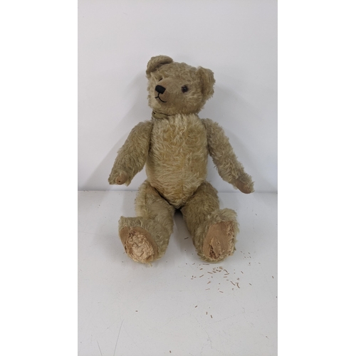 A 1920's Farnell teddy bear with golden coloured mohair, kapok and wood stuffed, with a black stitched mouth and nose, black and amber glass eyes, a swivel head and moving limbs, British made
Location:RWB

If there is no condition report shown, please request