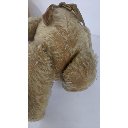 191 - A 1920's Farnell teddy bear with golden coloured mohair, kapok and wood stuffed, with a black stitch... 