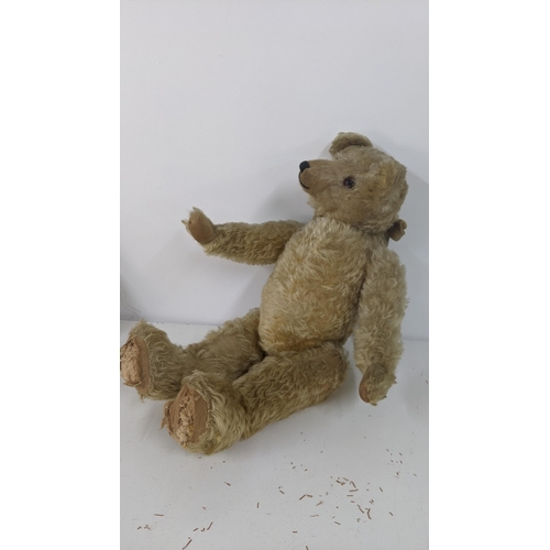 191 - A 1920's Farnell teddy bear with golden coloured mohair, kapok and wood stuffed, with a black stitch... 