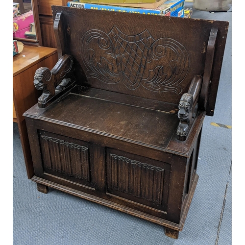 197 - An early 20th century oak carved monk's bench having linenfold front panels and underseat storage 97... 