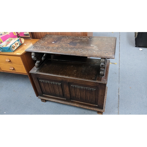 197 - An early 20th century oak carved monk's bench having linenfold front panels and underseat storage 97... 