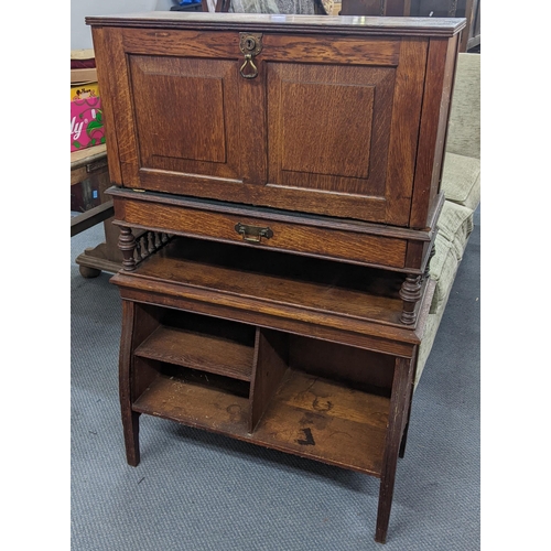 215 - An Edwardian oak students bureau having a fall flap with a fitted interior and open shelves below, 1... 