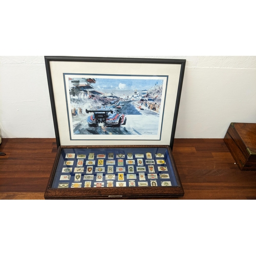 216 - The Official Emblems of the Worlds Greatest Automobiles, in a case and signed prints of a Porche
Loc... 