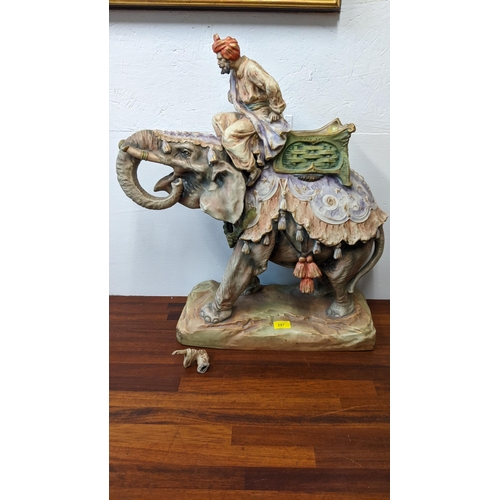 297 - An Austrian Art Nouveau imperial Amphora porcelain model of an Arabian scout on an elephant, signed ... 