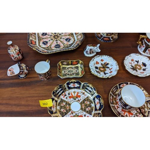 302 - Royal Crown Derby Imari and vine pattern china to include a Tazza, a set of six plates, a paperweigh... 