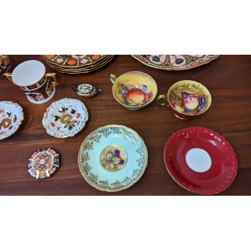 302 - Royal Crown Derby Imari and vine pattern china to include a Tazza, a set of six plates, a paperweigh... 