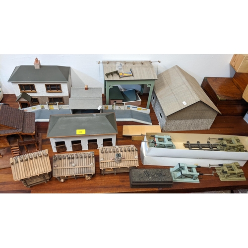 306 - Model railway buildings and related collectables to include houses, sheds, stables and Bassett Lowke... 