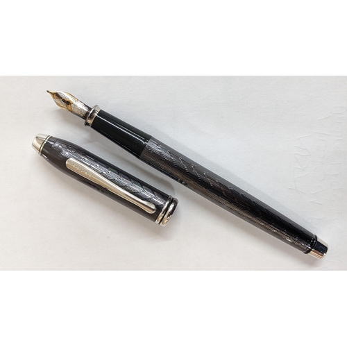 330 - A cross fountain pen with an engine turned case and an 18ct white and yellow gold nib
Location:CAB

... 