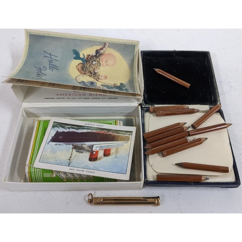 332 - A 9ct gold Sampson Mordan propelling pencil, 3.4g, together with pencils and cigarette cards
Locatio... 