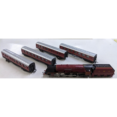 56 - A Hornby 00 gauge Duchess of Sutherland model locomotive and three carriages, in some of its origina... 