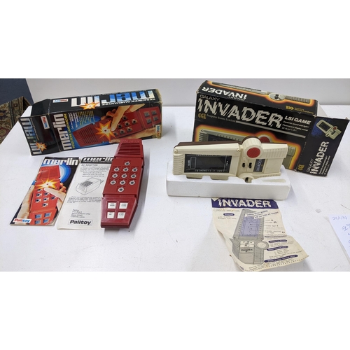 71 - Two retro electronic games in their original boxes to include a Galaxy Invader and a Palitoy Merlin ... 