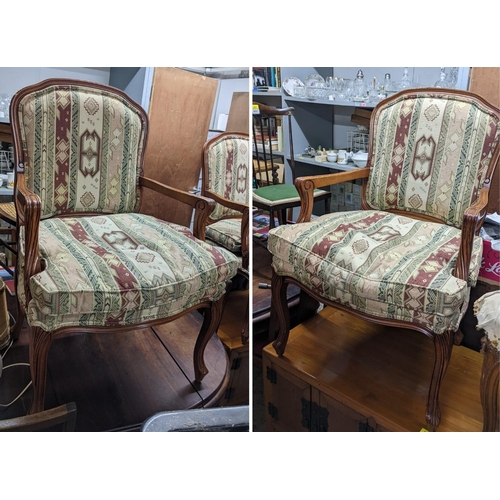 130 - A pair of late 20th century walnut finished open arm chairs, on cabriole legs
Location: G

If there ... 