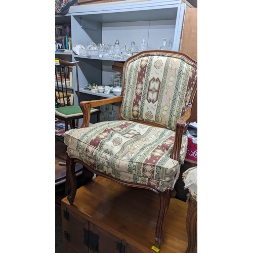 130 - A pair of late 20th century walnut finished open arm chairs, on cabriole legs
Location: G

If there ... 