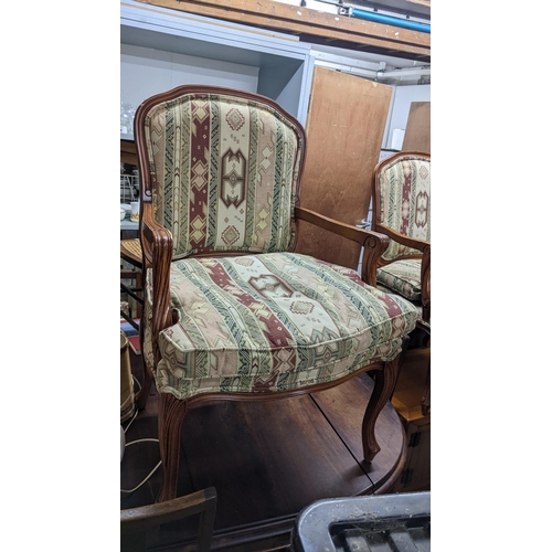 130 - A pair of late 20th century walnut finished open arm chairs, on cabriole legs
Location: G

If there ... 