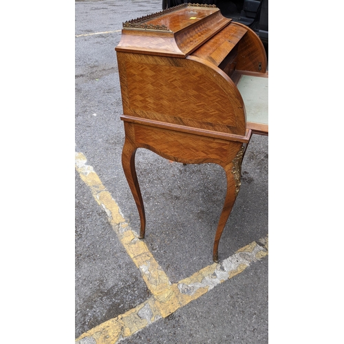 220 - A late 19th century French mixed veneered cylinder desk with gilt metal mounts, with a fitted interi... 