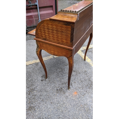 220 - A late 19th century French mixed veneered cylinder desk with gilt metal mounts, with a fitted interi... 