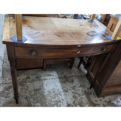 266 - A Regency mahogany bow fronted side table with single drawer on ring turned legs Location:G
If there... 