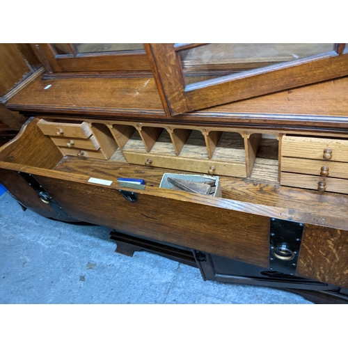 319 - A Victorian oak bookcase secretaire, the top with dentil moulded cornice above twin glazed doors and... 