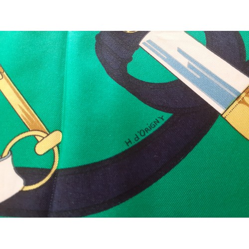 6 - Hermes- A 1980's green and navy silk 'Eperon d'Or' scarf designed by H. d'Origny with gold coloured ... 