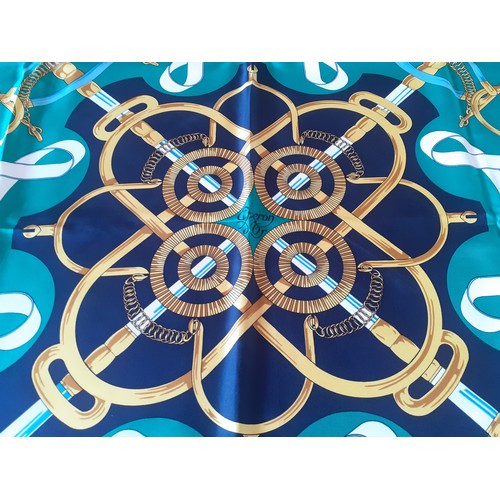 6 - Hermes- A 1980's green and navy silk 'Eperon d'Or' scarf designed by H. d'Origny with gold coloured ... 