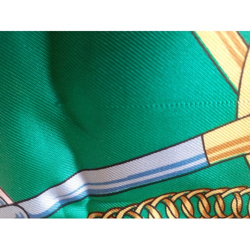 6 - Hermes- A 1980's green and navy silk 'Eperon d'Or' scarf designed by H. d'Origny with gold coloured ... 