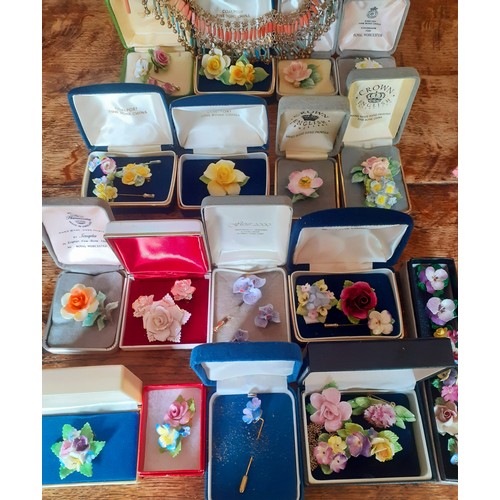 140 - A collection of china posy jewellery to include Coalport brooches, Royal Worcester brooches, Aynsley... 