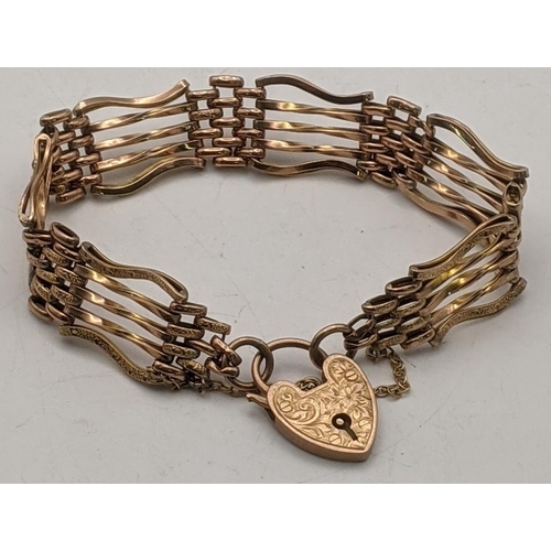 46 - A 9ct gold rose gold gate line bracelet having a heart shaped clasp, with engraved floral decoration... 