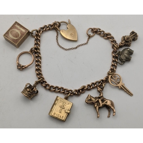47 - A 9ct rose gold charm bracelet having 8 gold charms to include a shilling bob note charm emergency b... 