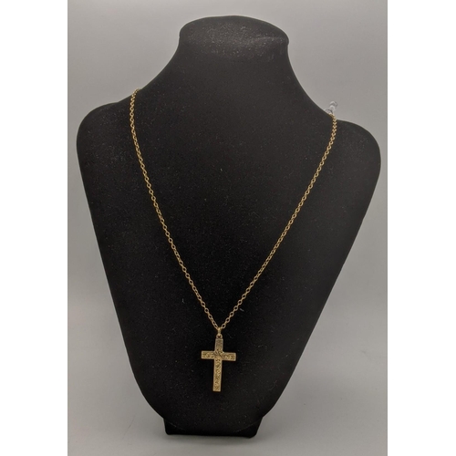 49 - A 9ct gold cross pendant having a floral engraved design, on a gold necklace, tested as 9ct gold, to... 