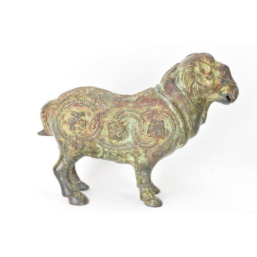 135 - A Chinese patinated bronzed Zodiac model of a ram, relief decorated with snakes, dragons and repeati... 