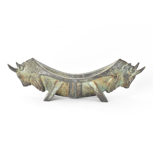 133 - A 20th century Chinese patinated bronzed oblong shaped bowl, the sides fashioned as two bulls heads ... 