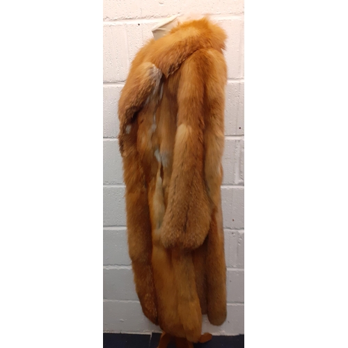 72 - A group of fur coats to include a late 1970's/early 1980's red fox calf length coat A/F with shawl c... 