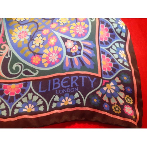 8 - Liberty-A silk wrap, unworn with original tags, in pinks, blues and green with hand rolled black bor... 