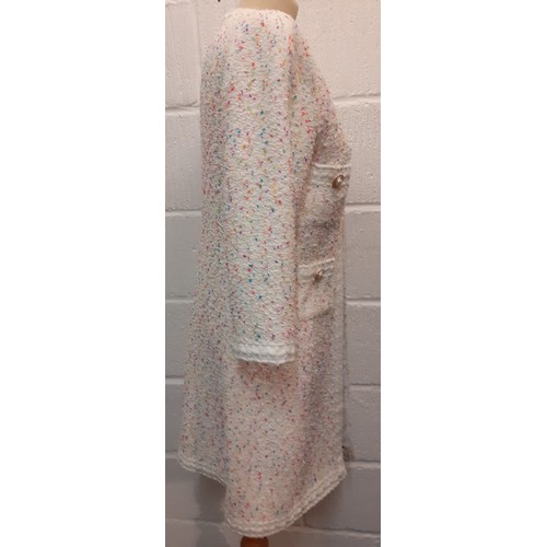 9 - Edward Achour, Paris-A white ground boucle coat in the style of Chanel having multi coloured flecks,... 