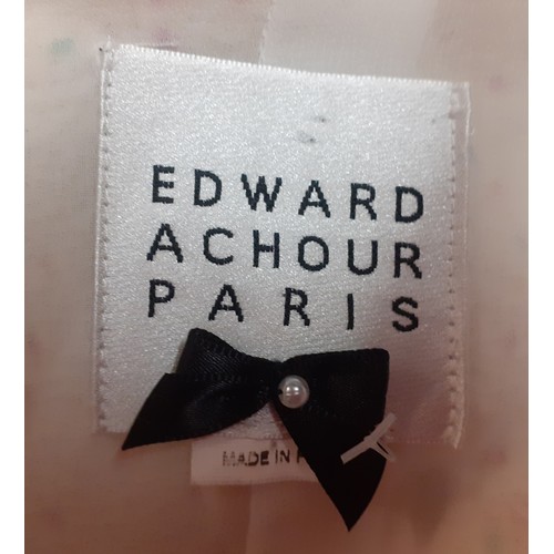 9 - Edward Achour, Paris-A white ground boucle coat in the style of Chanel having multi coloured flecks,... 