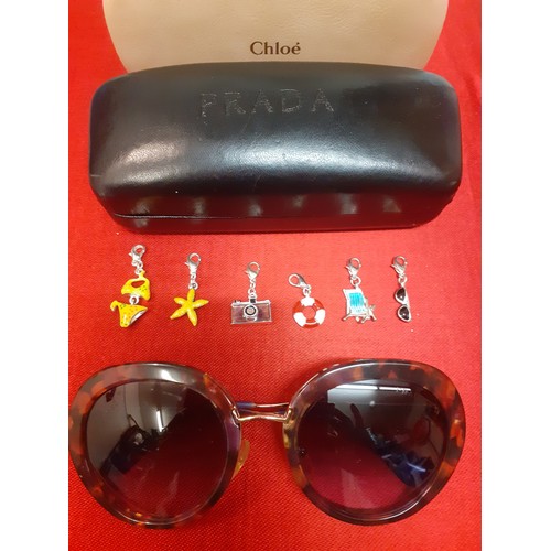 15 - Prada-A pair of vintage over-sized sunglasses with mock tortoiseshell frame, gold tone and purple te... 