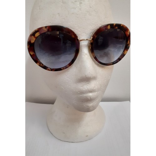 15 - Prada-A pair of vintage over-sized sunglasses with mock tortoiseshell frame, gold tone and purple te... 