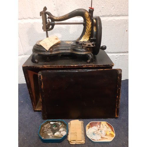 73 - Circa 1890's, a Jones hand cranked sewing machine having a serpentine swan neck  with wooden case an... 