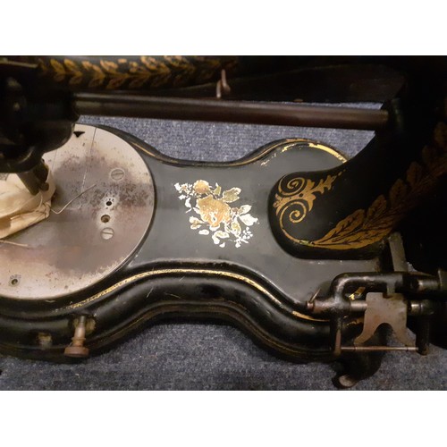 73 - Circa 1890's, a Jones hand cranked sewing machine having a serpentine swan neck  with wooden case an... 