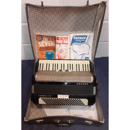 179 - A Hohner Carena IIIM accordion with sheet music in travel case together with a vintage projector. Lo... 