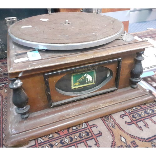 183 - An HMV gramophone on oak base A/F requiring restoration with brass horn together with 4 record cases... 